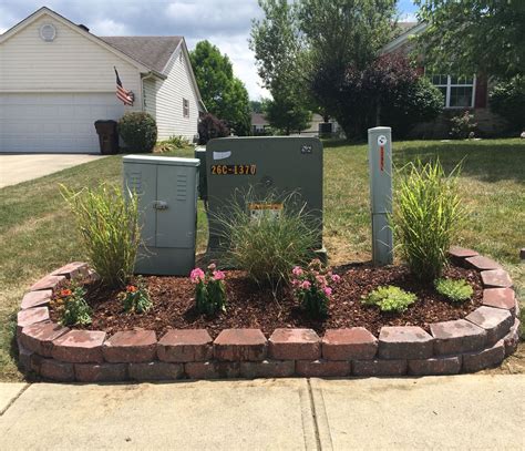 creative way to hide large electrical box in yard|hiding electrical boxes in yard.